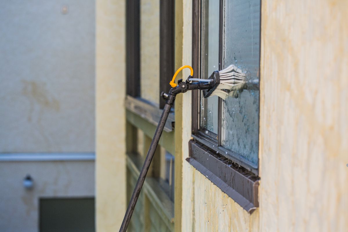 A window cleaning machine in action, effectively cleaning a large glass window.